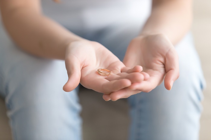 Girl holding a wedding ring in her hands