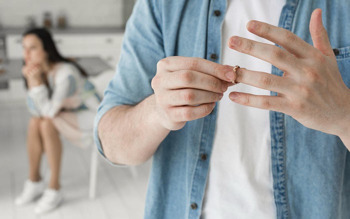 Man taking off his wedding ring from his finger