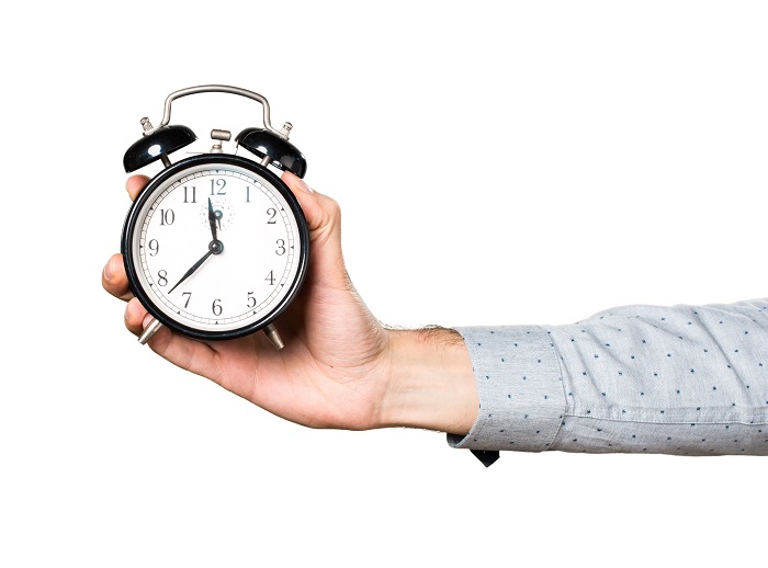 Man's hand holding a watch