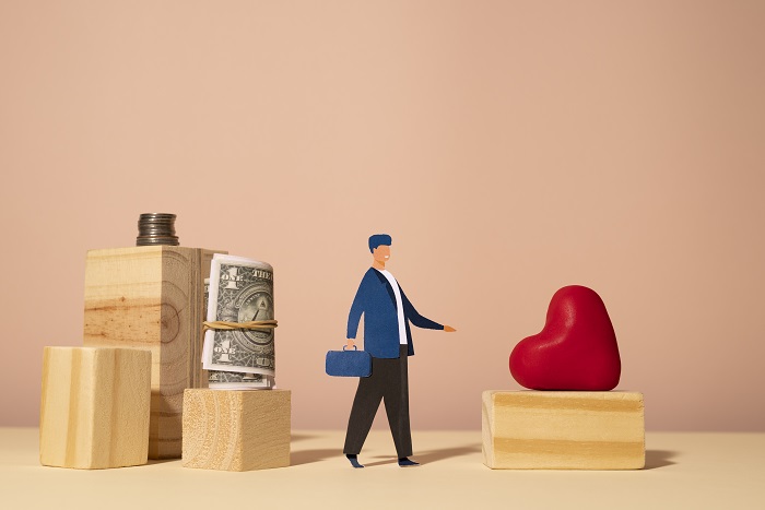 Man standing between money and heart